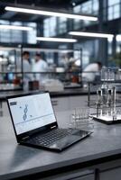 Laptop displaying DNA sequence in modern lab setting. Scientists working in the background photo
