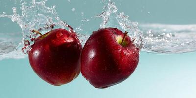 Two red apples are splashing in water photo