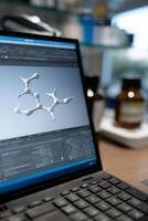 Laptop displaying 3D molecular model in a lab setting photo