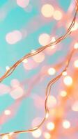 Copper wire string lights glowing against a teal background, creating a warm festive and bokeh effect. Abstract background photo