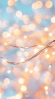 Glowing string lights bokeh soft muted illumination against casting blue background. Abstract background photo