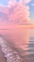 Soft pastel pink sunset reflecting on calm ocean water with gentle washing wave ashore. Abstract background photo