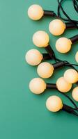Warm light bulbs hanging against a green backdrop, evoking a festive holiday Abstract atmosphere. background photo
