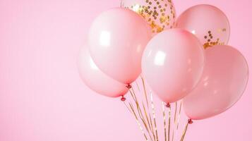 Airy pink and gold balloons creating a festive atmosphere against a with pink background adorned solid scattered confetti photo