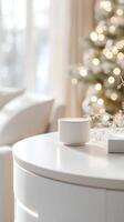 Christmas still life with cozy candles and white decorative branches on a small table in a burning white living room photo