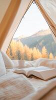 interior tent Mountain featuring plush bedding, soft morning light illuminating rugged peaks through canvas opening photo