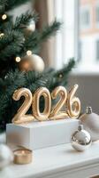 lights, foil balloons forming the number 2026 stand on a light blue surface with christmas decorations and blurred Pink celebrating the upcoming new year photo