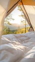 Mountain plush interior featuring tent bedding, soft morning light illuminating rugged peaks through canvas opening photo