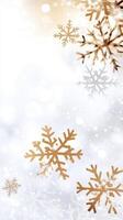Golden and silver snowflakes falling softly creating a festive christmas atmosphere on a blurred snowy background photo