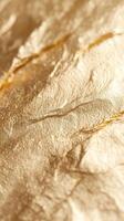 Close up of crumpled gold leaf, showcasing its unique texture and shimmering ideal surface, for luxury design projects photo