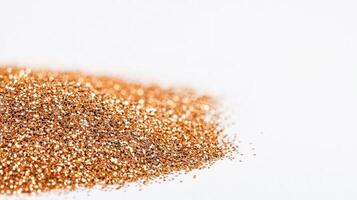 Golden glitter forms a shimmering creating on a white surface, pile a luxurious and festive backdrop photo
