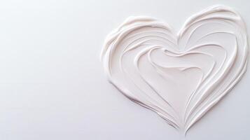 Neutral toned cosmetic cream spreading in heart shape, symbolizing skincare elegance against pristine white surface photo