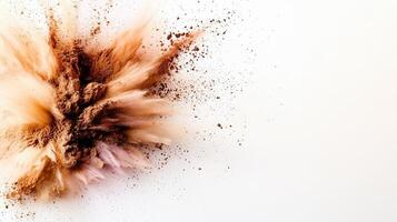Brown powder exploding on a white background, creating a colorful cloud particles of different sizes photo