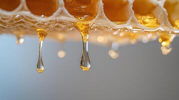 Golden honey cascading from honeycomb, revealing rich amber flow glossy, with sticky texture and natural sweetness photo