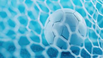 White soccer ball piercing goal intense dynamic blue toned background capturing scoring moment during net, match photo