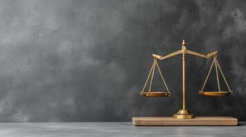 Golden scales balancing on justice, wooden base represent the concept of a law, and equality before a dark gray background photo
