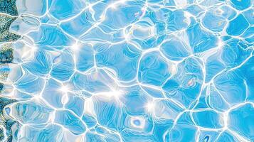 Sunlight reflecting on rippling pool surface, casting shimmering light patterns against dancing water shadows photo