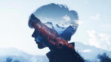 Double exposure image of man containing silhouette profile mountain landscape with trees, snow and clouds photo