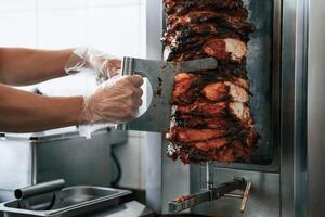 Chef preparing, and making traditional Turkish Doner Kebab meat. Shawarma or gyros photo