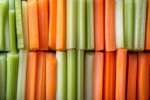 Freshly cut carrot and celery sticks forming a colorful and healthy pattern photo