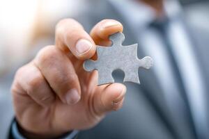 Businessman holding jigsaw puzzle piece representing problem solving and business solutions photo