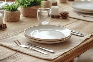 Table setting featuring rustic placemats, empty plates, and festive decorations photo