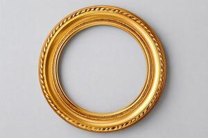 Round golden frame hanging on a gray wall, creating a stylish and elegant display photo