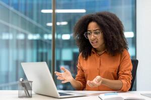 Angry and dissatisfied businesswoman looking at laptop screen. Employee received computer error and software failure photo