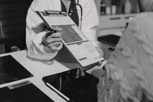 A doctor is holding a clipboard while looking at a patient photo