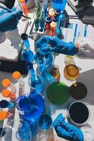 A table with many different colored liquids and test tubes photo