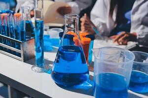 A table with several test tubes and blue liquid photo