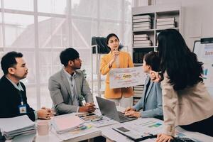 A group of people in an office meeting photo