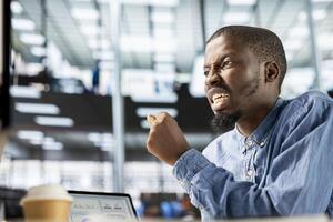 General manager sits at his computer frustrated and overwhelmed by the workload of business tasks. Entrepreneur dealing with fatigue after experiencing pressure at the workplace. photo
