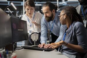 Worried computer scientists in data center reacting to virus alert, initiating protocol to protect systems. Server room staff members cooperating, assessing compromised gear after hacker attack photo