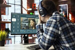 Man in home office uses generative artificial intelligence GPT with image understanding capabilities generating videos. Person getting help from AI virtual assistant producing clips from prompts photo