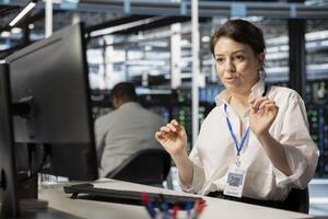 Data center technician inspecting gear, doing maintenance tasks, checking performance diagnostics. Server farm employee conducting system checks to ensure operational stability across network rigs photo