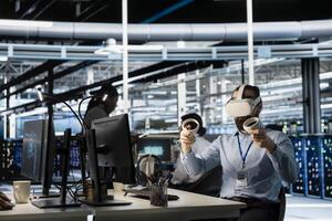 Engineer in data center using VR headset tech to verify neural network parameters. Server hub IT expert using virtual reality to inspect configurations, ensuring optimal application performance photo