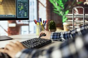 Freelancer in home office using virtual home interior design software to help visualize changes to designs. Close up of person using architectural design software to manage home enhancement project photo
