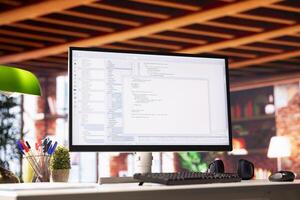 Lines of code written on PC workstation display on development tool application, close up. Debugging software programming language displayed on computer monitor in living room office photo
