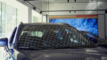 Close up shot of showcased cars with sleek design in showroom waiting to be purchased by interested customers. Modern vehicle models in dealership being promoted for potential clients photo