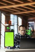 Close up of isolated screen tablet used by worker in home office analyzing data charts, identifying trends. Freelancer using chroma key device, compiling analytical reports, processing data photo