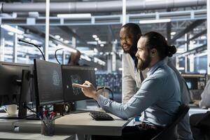 Team of programmers using computer in data center, integrating AI driven automation tools. Server farm IT experts working together, using artificial intelligence machine learning models photo