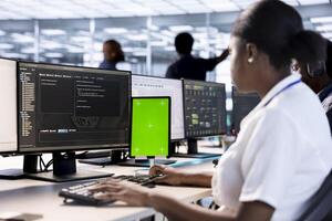 Server room computer scientist using green screen tablet to find firewall misconfigurations. IT specialist checking systems bottlenecks leading to sluggish data transfer rates using mockup device photo