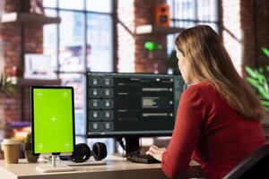 Person utilizes a digital AI tool on web interface next to green screen, doing remote work. Artificial intelligence powered interface simplifies communication and increases efficiency. photo