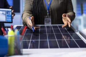 Scientists conduct research and development on solar panel efficiency, analyzing photovoltaic materials in high tech factory to enhance renewable energy production, close up shot photo