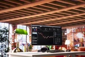 Application on computer screen in apartment used for analyzing crypto coins investment graph fluctuations. Forex volatile assets candlestick chart on PC monitor on home office desk photo