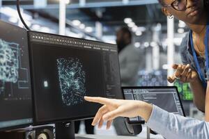 Close up of manager supervising admin using computer in data center office, integrating AI driven automation tools. Server farm team leader and worker use artificial intelligence deep learning models photo