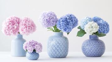 Delicate hydrangeas in pastel vases. photo