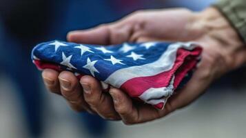 A folded flag held tenderly in a person's hand. photo