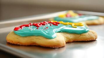 Close-up of two decorated cookies on a metal tray. photo